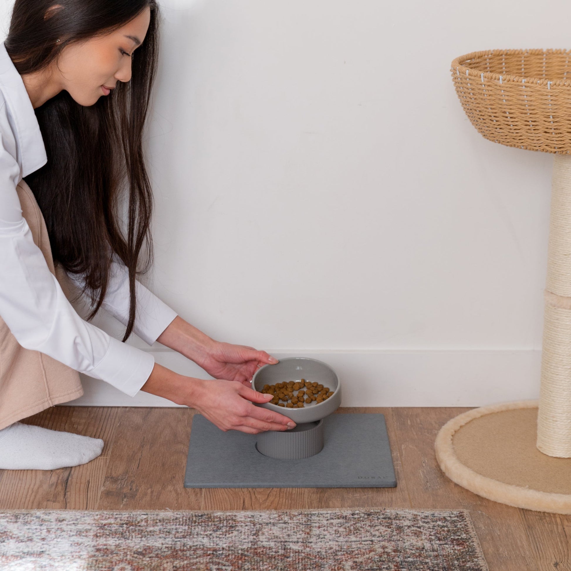modern ceramic cat bowl being put on top of silicone riser